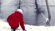 Girls playing with snow on river's edge