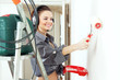 Photo: Happy girl makes repairs at home Happy girl makes repairs at home