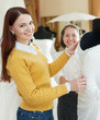 Photo: Girl chooses bridal dress at wedding store Girl chooses bridal dress at wedding store