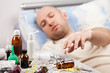 Photo: Unwell man patient lying down bed Unwell man patient lying down bed
