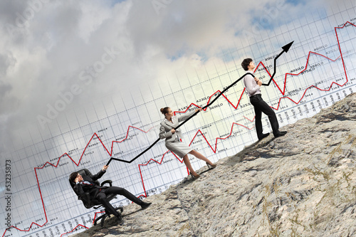 Photo: Businesspeople pulling graph Businesspeople pulling graph
