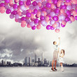 Family holding colorful balloons