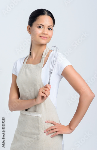 Photo: Woman baker holding kitchen whisk Woman baker holding kitchen whisk