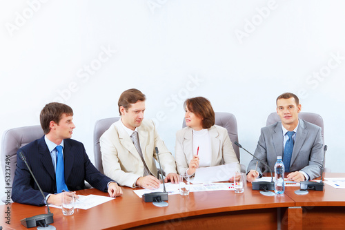 Photo: Four businesspeople at meeting Four businesspeople at meeting