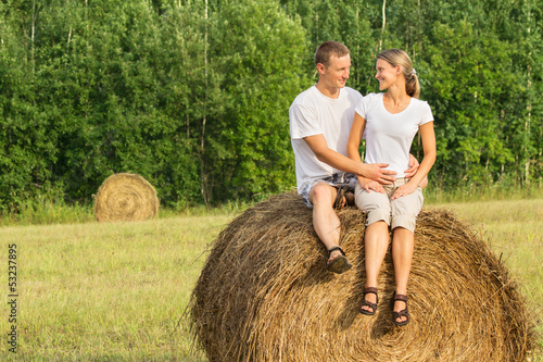 Photo: Two young lovers on haystack Two young lovers on haystack