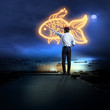 Businessman drawing gold fish