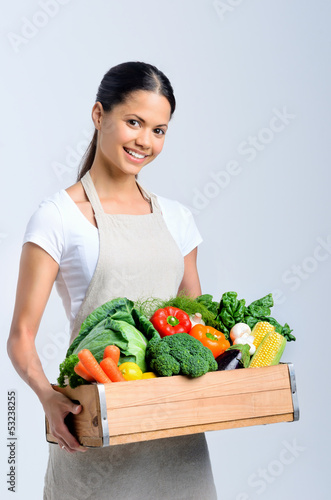 Photo: Healthy happy woman with crate of vegetables Healthy happy woman with crate of vegetables