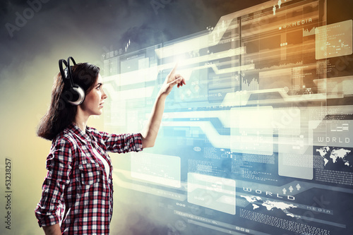 Photo: Woman touching virtual screen Woman touching virtual screen