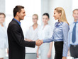 man and woman shaking their hands