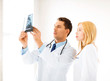two doctors looking at x-ray