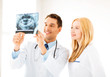 two doctors looking at x-ray