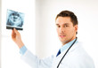 male doctor or dentist with x-ray