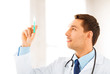 male doctor holding syringe with injection
