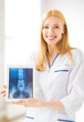 female doctor with x-ray on tablet pc