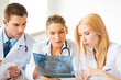 young group of doctors looking at x-ray