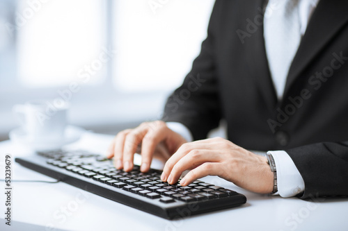 Photo: man hands typing on keyboard man hands typing on keyboard