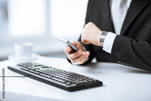 Photo: man hands with keyboard, smartphone and wristwatch man hands with keyboard, smartphone and wristwatch