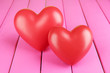 Decorative red hearts on color wooden background
