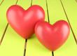 Photo: Decorative red hearts on color wooden background Decorative red hearts on color wooden background
