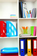 White office shelves with different stationery, close up