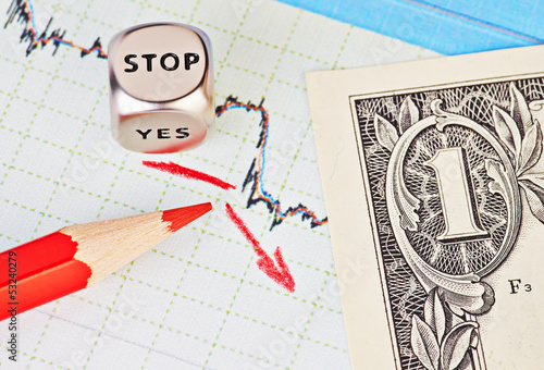 Photo: Downtrend financial chart, red pencil, red arrow, dices cube wit Downtrend financial chart, red pencil, red arrow, dices cube wit