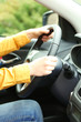 Female hands over a wheel in the car, close up