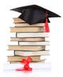 Grad hat with diploma and books isolated on white