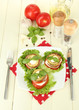 Tasty roasted marrow and tomato slices with salad leaves,