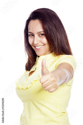 Photo: Beautiful young woman showing thumbs up, isolated over a white b Beautiful young woman showing thumbs up, isolated over a white b