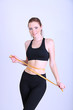 Photo: Beautiful young woman with measuring tape Beautiful young woman with measuring tape