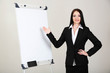 Businesswoman presenting on whiteboard.