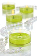 Lighted candles with beads close up