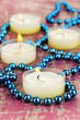 Lighted candles with beads close up