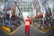 Photo: worker in red uniform with box in the warehouse in fish-eye lens worker in red uniform with box in the warehouse in fish-eye lens