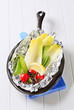 Fresh vegetables on tinfoil in skillet