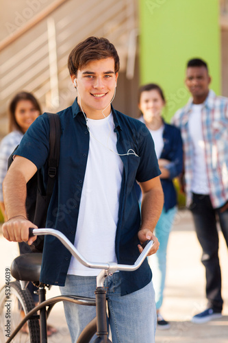 Photo: male teen high school student with a bicycle male teen high school student with a bicycle