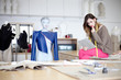 Photo: Fashion designer looking at designs on tablet computer. In the s Fashion designer looking at designs on tablet computer. In the s