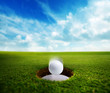 Photo: Golf Ball falling into hole Golf Ball falling into hole