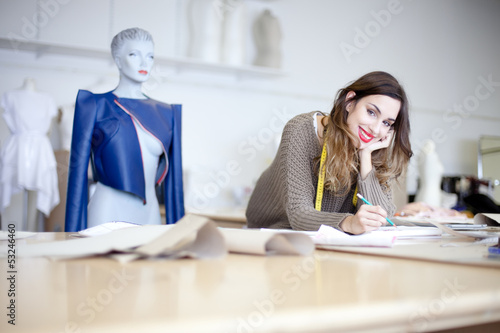 Photo: Fashion designer working on designs in the studio Fashion designer working on designs in the studio