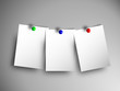 Three white papers on gray wall