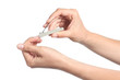 Woman hands using a nail clippers to cut her fingernails