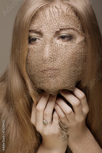 Photo: blond woman with gunny mask blond woman with gunny mask