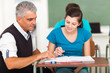 mature high school teacher helping student
