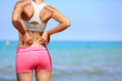 Photo: Back pain - Athletic woman rubbing her back Back pain - Athletic woman rubbing her back
