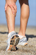 Photo: Sport injury - Man running clutching calf muscle Sport injury - Man running clutching calf muscle