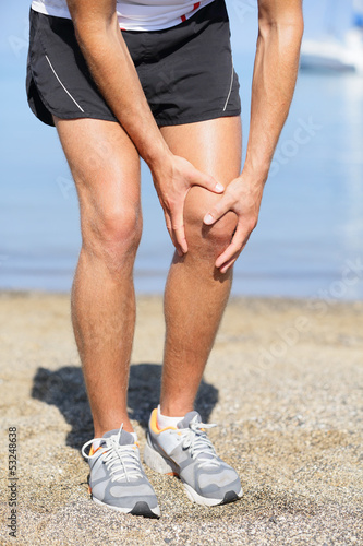 Photo: Running injury - Man out jogging with knee pain Running injury - Man out jogging with knee pain