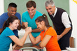 female high school students arm wresling