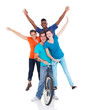 Foto: group of teenagers riding one bicycle group of teenagers riding one bicycle
