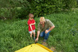  Father with children installing their tent