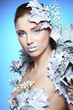 Photo: Young woman in creative image with silver artistic make-up. Young woman in creative image with silver artistic make-up.